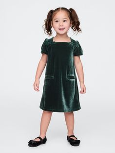 Soft, stretch velour dress.  Square neck with back button closures.  Short puff sleeves.  Bow details at front.  Front welt pockets.  This dress is made with 95% recycled polyester.  Compared to virgin materials, using recycled materials helps to reduce resource use and waste.  Shift silhouette with an easy fit.  Hits at the knee.  Sizes range from baby to toddler. Christmas Kids Outfits, Essex Green, Black Toddler, Kids Christmas Outfits, Dress Square Neck, Toddler Dresses, Velour Dress, Baby Gap, Toddler Dress