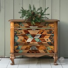 an old dresser has been decorated with wood and pine cones for christmas time, as well as greenery