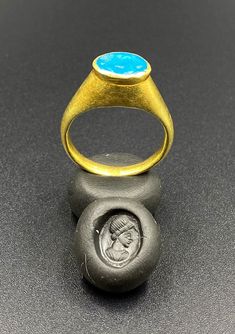 The Beautiful Gold Ring Probably From Ancient Greek's Time With Turquoise Color Blue Glass Stamp. A Beautiful Head Of A Man Figure Engraved On This Blue Glass. Seals Was Mostly Carved In Carnelian Or Garnet In Ancient Times But On Glass Very Rare. We Can Provide Gold Certificate On Customers Request.18 Karat Gold. We Provide Fast And Free Shipping World Wide. Blue Cabochon Signet Ring For Anniversary, Blue Intaglio Ring As Gift, Luxury Blue Turquoise Ring For Formal Occasions, Blue Oval Hallmarked Signet Ring, Luxury Blue Oval Cabochon Ring, Luxury Blue Ring With Oval Cabochon, Luxury Blue Turquoise Ring Gift, Blue Cabochon Signet Ring, Handmade Classic Blue Signet Ring