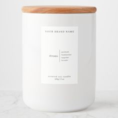 a white candle with a wooden lid and label on it that says your brand name