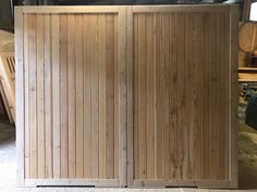 two wooden doors sitting next to each other on top of a floor in a room