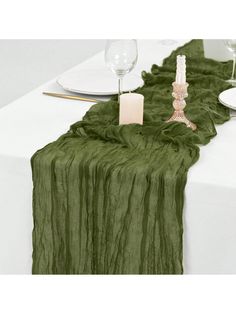 the table runner is green and has candles on it