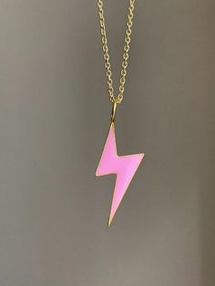 925 sterling vermeil pink enamel bolt charm necklace.Necklace measures 18" in length.Cable style chain with spring ring clasp.18KT gold plate over sterling silver.Bolt charm measures 1/2" W x 1 3/8" L.Follow us on instagram @pennyweightsjewelry! Pink Pendant Charm Necklace, Trendy Pink Sterling Silver Jewelry, Pink Cable Chain Jewelry Gift, Trendy Pink Sterling Silver Necklaces, Trendy Pink Sterling Silver Necklace, Pink Cable Chain Necklace Gift, Pink Cable Chain Necklace As Gift, Pink Cable Chain Necklace For Gift, Pink Sterling Silver Charm Necklaces