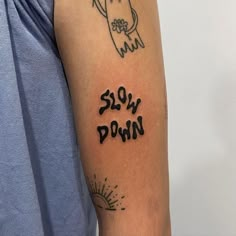 a man with a tattoo on his arm that says slow down and an image of a hand holding a flower