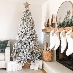 a decorated christmas tree sitting in front of a fireplace