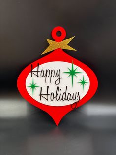 a happy holidays ornament hanging on a wall