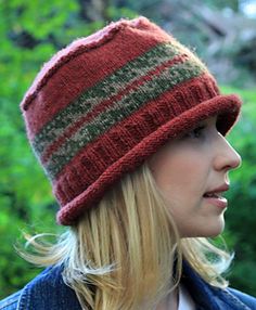 a woman with blonde hair wearing a red and green striped knitted beanie hat