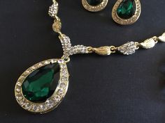 "** This necklace comes with a matching bracelet together with a pair of earrings (studs at back design). ** Featuring lovely teardrop shaped pendants embellished with clear rhinestones crystals and green glass stones on top. Great to wear on your wedding day or party event!! Color: gold plated with clear rhinestone crystals and green glass stones Size: necklace measures around 19\" long x center 2\" drop x 1\" width, bracelet 8.5\" long x 0.75\" width and earrings 1.35\" long x 0.75\" width ** Emerald Pear-shaped Necklace For Wedding, Emerald Pear-shaped Wedding Necklaces, Elegant Green Rhinestone Jewelry Sets, Elegant Green Jewelry Sets With Rhinestones, Emerald Teardrop Pendant Necklace For Weddings, Elegant Emerald Teardrop Pendant Necklace For Weddings, Pear-shaped Emerald Necklace For Wedding, Emerald Drop Jewelry For Weddings, Emerald Teardrop Pendant For Wedding