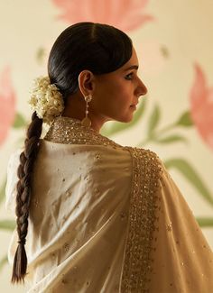 This beautiful ivory and gold Chanderi silk Kurta set exudes grace and elegance, featuring intricate embroidery adorned with sequins, pearls, and cutdana work. The anarkali top has a regal flair with delicate embellishments along the neckline, sleeves, and hemline, adding a luxurious touch to the traditional design. The flowy silhouette is paired with matching straight-cut trousers, offering both comfort and style. Completing the ensemble is a matching ivory dupatta embellished with gold embroidery, which perfectly complements the intricate details of the anarkali. Perfect for pre wedding festivities. Composition: Chanderi Silk Care: Dry Clean Only and Vacuum Storage This product can be customised for sleeves, length of blouse and neckline Delivery : 6-8 weeks as the product is hand crafte Elegant Off-white Lehenga For Festive Occasions, Elegant Unstitched Sharara With Pearl Embroidery, Elegant Sharara With Pearl Embroidery, Elegant Off White Dupatta For Reception, Elegant Off-white Dupatta For Reception, Bollywood Designer Saree With Pearl Embroidery, Off White Silk Anarkali Set With Dupatta, Cream Silk Anarkali Set, Elegant Sets With Pearl Embroidery For Diwali