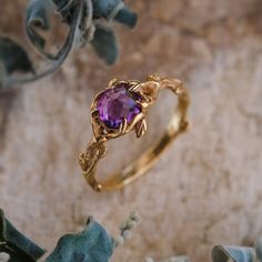 "Let the \"April\" Gold ring be your personal symbol of undying love and all the magic happening around you. Floral motifs, romantic handmade design and otherworldly genuine Amethyst serenade together to express into the highest form of art. DETAILS - 14K Yellow Gold - Natural Amethyst - Amethyst size: 7mm - Nature inspired design - Made to order by hands - Great attention to details - Lifelong Warranty The \"April\" ring is custom made in any size between 3 to 11 in American/Canadian measuremen Gold Ring With Amethyst, Amethyst Ring Aesthetic, Amethyst Engagement Ring Gold, Gold Ring Purple Stone, Yellow Gold Amethyst Wedding Ring, 14k Gold Amethyst Ring, Vintage Gold Amethyst Ring For Wedding, Amethyst Engagement Ring Vintage, Gold Amethyst Wedding Ring With Gemstone Accents