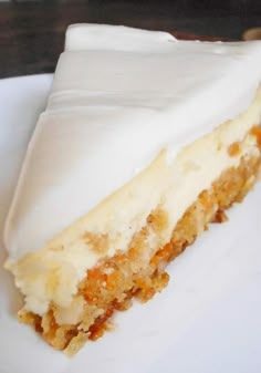 a piece of cake sitting on top of a white plate covered in frosted icing