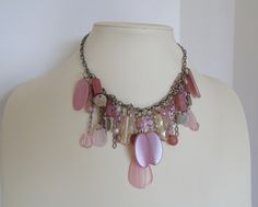 Girlish and playful, a tender, romantic, pastel colored short necklace from the '80s. Plenty of synthetic but of very good quality beads, in various shepes, beaded on a thich, silver tone chain. An authentic vintage piece of jewelry that could be worn at a party, a walk, even a wedding reception. In perfect condition. Please note that this is not a new item, so it is expected to have time signs on it. This is exactly what makes it unique. Feminine Pink Choker Necklace, Handmade Pink Chain Necklace, Vintage Pink Choker Necklace, Pink Beaded Chain Costume Jewelry Necklace, Pink Beaded Chain Costume Necklaces, Vintage Handmade Pink Necklace, Handmade Vintage Pink Necklace, Vintage Pink Beaded Necklace As A Gift, Pink Vintage Beaded Necklaces With Colorful Beads