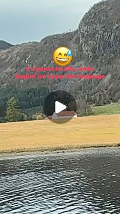 a lake with mountains in the background and an emoticive message written on it