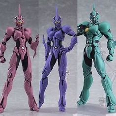 three action figures in different colors and sizes