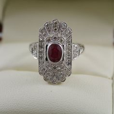 FABULOUS ANTIQUE ART DECO STYLE RING COMES WITH RECENT VALUATION RETAIL CERTIFICATE HAND MADE ART DECO STYLE RING THIS GORGEOUS RING IS SET Oval Ruby Ring In Platinum For Anniversary, Platinum Ruby Ring With 17 Jewels, Exquisite Oval Ruby Ring In White Gold, Oval Ruby Ring In Platinum For Gift, Oval Ruby Ring In Platinum, Formal Hallmarked Ruby Ring In Platinum, Formal Hallmarked Platinum Ruby Ring, Exquisite 14k White Gold Promise Ring, 14k White Gold Ruby Ring With Halo Setting