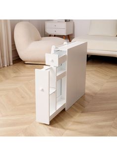 an open cabinet in the middle of a living room with white furniture and wood flooring