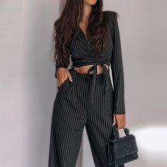 Step into sophistication and timeless elegance with the Hot Fashionista Kitty Even Keeled Pinstripe Trouser Pant Set in Black Striped, a chic ensemble that exudes confidence and style. This impeccably tailored set features a sleek blazer and matching trousers, both adorned with classic black pinstripes that lend a touch of refinement to the ensemble. The blazer boasts a structured silhouette with notched lapels and a single-button closure, exuding professionalism and sophistication. Complementing the blazer, the trousers feature a high-waisted design and a straight-leg silhouette that elongates the legs for a flattering fit. The pinstripe pattern adds a hint of sartorial flair, while the tailored construction ensures a polished and put-together look. Perfect for the office, a business meet Crop Top Swimwear, Pinstripe Pattern, Loose Maxi Dress, Linen Shirt Dress, Shirt Dress Casual, Grey And Beige, White Maxi Dresses, Pant Set, Midi Dress Bodycon