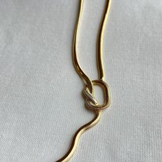 This Angela Knot Necklace will give your look a modern edge! Crafted with a snake chain, it's the perfect piece to add a little twist to your wardrobe. 13.5" + 3" Ext. 18k Gold Plated Over Stainless Steel Hypoallergenic Water & Tarnish Resistant Taper Candle Holders, A Snake, Knot Necklace, Signature Scent, Original Gift, Pillow Pattern, Cz Stone, Snake Chain, Jewelry Care