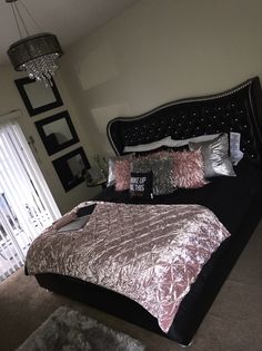 a bedroom with a large bed and chandelier