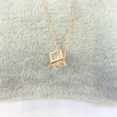 - Cube pendant necklace is made with high-quality 14K real solid gold. - The Inside of the cube, there is a diamond cut cubic zirconia stone and it is moving. - The dimensions of the cube is 0.5 X 0.5 X 0.5 cm. - This dainty, charm, tiny, delicate, cute and trendy pendant necklace has been artfully designed for timeless yet modern millennial fashion. - This 14K solid gold pendant comes with a beautiful matching free 14K real solid gold chain. - You receive the pendant in a beautiful and free gif Square Pendant Solitaire Necklace With Diamond Cut For Gift, Fine Jewelry Solitaire Necklace With Square Pendant As Gift, Diamond Cut Solitaire Necklace With Square Pendant For Gifts, Square Diamond Cut Solitaire Necklace As Gift, Diamond Cut Solitaire Necklace With Square Pendant, Square Pendant Diamond Cut Necklace As Gift, Gift Diamond Necklace With Square Pendant, Fine Jewelry Square Pendant Necklace For Gift, Diamond Box Chain Necklace For Gift