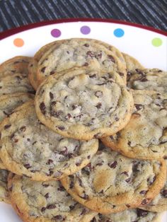 chocolate chip cookies stacked on top of each other in a white and red plate with polka dots