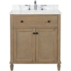 a bathroom vanity with a white marble top and two drawers on one side, the sink is