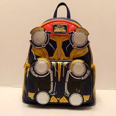 a back pack with an iron man design on the front and two speakers attached to it