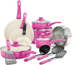 pink pots and pans with utensils on the bottom one has a spatula