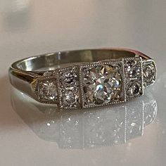 Details: Sweet vintage inspired Art Deco Style diamond and platinum step ring with just under 1 carat of diamonds! This ring has so much sparkle, and life--hard to capture in a photo but it shines bright! This ring was designed by our amazing jeweler Scott Eerkes, and lovely vintage diamonds. Would make a fabulous engagement or wedding ring! Would look great in a ring stack! This ring comes with an appraisal. Appraisal: Cut: European Carat Weight: 0.59 carat (Estimated) Measurements: 5.40 x 3.14 Art Deco Platinum Diamond Ring With Vvs Clarity, Art Deco Platinum Diamond Ring With Round Cut, Art Deco Diamond Ring With Center Stone, Classic Silver Moissanite Diamond Ring, Platinum Art Deco Diamond Ring With Round Cut, Baguette Cut Cluster Ring With Single Cut Diamonds, Art Deco Platinum Diamond Ring With Single Cut Diamonds, Art Deco Platinum Diamond Ring With Brilliant Cut, Dazzling Diamond Ring With Single Cut Diamonds