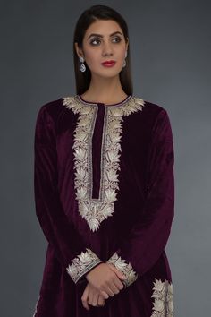 Plum purple long straight kurta with placement floral motif work. Comes with pants.
Components: 2
Fabric: Velvet,Pure Silk
Neckline: Round
Sleeve Length: Full
Color: Purple
Embroidered
Straight kurta with side slits
Straight pants
Closure: Kurta: Front concealed hook placket - Aza Fashions Makhmal Suits Design, Tilla Work Embroidery Suits, Tilla Work Embroidery, Plum Suit, Indian Wedding Guest Dress, Kashmiri Suits, Long Tunics, Tilla Embroidery, Velvet Suit Design