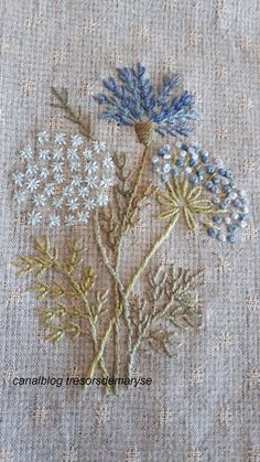 some flowers are embroidered onto a piece of fabric