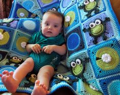 a baby laying on top of a crocheted blanket