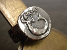 I handcrafted this mermaid jewelry unique silver statement ring using the wax seal technique from precious metal silver clay and sterling silver . The mermaid impression was made by pressing the image from a vintage intaglio into the metal clay. The metal clay is then fired in my studio kiln, which burns off all the impurities and turns the clay to fine silver. I then oxidized and polished it to define the image. The intaglio of the mermaid is a rare one, with a splendid image and nice details. Wax Seal Ring, Jewelry Wax, Fire Ring, Seal Ring, Silver Clay, Spring Valley, Mermaid Jewelry, Statement Ring Silver, Jewelry Unique