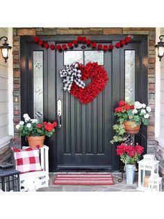 a front door decorated with red and white flowers