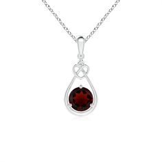 Suspended from a lustrous metal bale is an intricate loop knotted in the shape of a heart. While a deep red garnet is nestled at the base of the pear-shaped frame, a shimmering diamond accent sits atop the dainty knot heart. Crafted in platinum, this prong set floating garnet pendant necklace exudes a feminine aura. Feminine Aura, 2nd Wedding, 2nd Wedding Anniversary, Garnet Heart, Necklace With Diamond, Garnet Pendant, Root Chakra, Fine Jewellery Necklace, Red Garnet