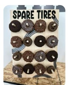 there is a sign that says spare tires with donuts on it and ribbons in the middle