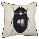 a black and white pillow with a beetle on it