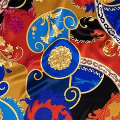 a close up view of an elaborately designed fabric with gold, blue and red colors