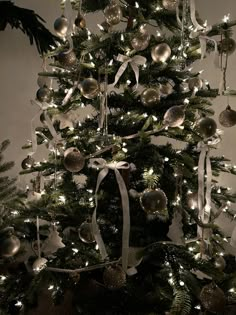 a christmas tree decorated with silver and white ornaments