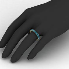 a woman's hand wearing a ring with blue stones on the inside of it