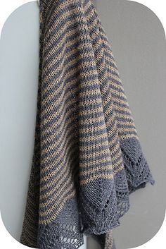 a gray and white striped towel hanging on a hook