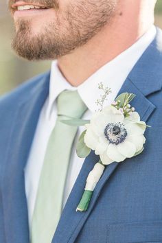 a man wearing a blue suit and green tie