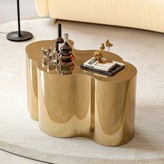 a gold coffee table with bottles and glasses on it