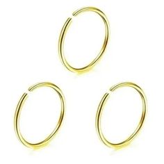 three pairs of gold plated metal hoop earrings on a white background with clippings