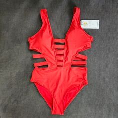 Tinibikini Orange Red Strappy Cut Out One Piece Women's Extra Small Xs Swimsuit Stand Out This Summer In This Bright Strappy Cutout One Piece Bathing Suit. This Stylish And Comfortable Swimsuit Is Made From A Blend Of Nylon And Spandex, Making It Perfect For Swimming, Sunbathing, And Other Water Activities. The Cutout Design And Strappy Details Add A Touch Of Sexy & Modern Style To This Classic One-Piece Whether You're Lounging By The Pool Or Hitting The Beach, This Tinibikini Strappy Cutout One Orange One Piece, Purple Swimsuit, Cutout One Piece, Lace Swimsuit, Green One Piece Swimsuit, Floral One Piece Swimsuit, Cut Out One Piece, Cut Out Swimsuits, Red Swimsuit