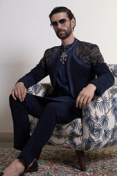 Navy blue bandhgala with placement hand embroidery, accentuated with golden stud work. Paired with an inner kurta and straight pant. - Aza Fashions Formal Choli With Traditional Drape For Eid, Formal Choli For Eid With Traditional Drape, Formal Traditional Drape Choli For Eid, Fitted Royal Blue Traditional Wear For Party, Traditional Embellished Nehru Jacket For Festive Season, Royal Blue Traditional Wear With Intricate Embroidery For Party, Traditional Embellished Festive Nehru Jacket, Fitted Nehru Jacket With Intricate Embroidery For Party, Party Nehru Jacket With Intricate Embroidery