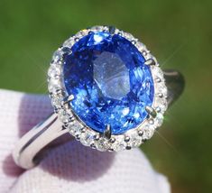 A Breathtakingly Striking  HANDMADE 14k White Gold Ring with Beautiful Oval cut Sapphire in Blue color! The GEM is 5.87 CT and measures 11.07x9.24x6.82 mm! This Stone will take your breath away, especially on the sunlight! You will want to look at this stone endlessly. The mounting is a masterpiece! HANDMADE 14K White Gold Mounting (tested), that was is custom made to Accommodate this Beauty of a Gem in Prongs setting! Super FINE Workmanship on the Diamond prong  setting with 22 pcs Brilliant Full Cut Diamonds in GH color, SI1 clarity, totaling to approx 0.38 ct ! Fabulous Braided Band and Diamond Gallery! The Entire Top's outline is 13.7x12.3 mm- HUGE. The Ring weights 5.3 g, nice and SOLID. Sits 8.2 mm off the top of the finger. Finger size 7 (Free Re-sizing with purchase). Center Stone: Oval Diamond Gemstones For Formal Occasions, Formal Oval Diamond Gemstones, Oval Platinum Gemstone With Center Stone, Oval Gemstones With Halo Setting For Formal Occasions, Luxury Oval Gemstones With Halo Setting, Exquisite Oval Brilliant-cut Gemstones, Exquisite Oval Brilliant Cut Gemstones, Luxury Oval Diamond Cut Sapphire Ring, Exquisite Oval Platinum Gemstones