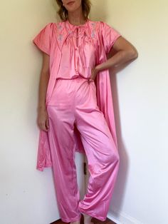 60s vintage bubble gum pink 3-piece sleep set / quilted and embroidered chest / includes pants, top, and robe that can also be worn as a dress on it's own / nylon / made by Vanity Fair ⚡️labeled size medium (modeled on size small, 5'5") ⚡️lying flat: top: shoulders 16" pit to pit 20" length 26" pants: waist 13"-17" hips 20" rise 13" inseam 27" robe/dress: shoulders 16" pit to pit 19.5" length 37.5" ⚡️no flaws of note ------------------------------------------------------------------------------- Vintage Pink Sleepwear For Spring, Vintage Sleepwear For Pajama Party In Spring, Vintage Pink Sleepwear For Pajama Party, Vintage Pink Sleepwear For Bedtime, Pink Vintage Sleepwear, Vintage Pink Spring Sets, Bubble Gum Pink, Embroidered Pants, 60s Vintage