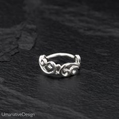 Beautiful Sterling silver nose ring for pierced nose. Tribal, ethnic, delicate design. Can be worn as an earring for the tragus, helix, earlobes & septum ring as well Material: Sterling silver 925 Wire Thickness: 0.8 mm - 20g Diameter of the ring: - 0.27Inc - 7mm *Nickel-free For other nose rings- https://www.etsy.com/shop/Umanativedesign?section_id=16881369&ref=shopsection_leftnav_6 We offer a range of septum rings, for pierced and non- pierced noses, made of different materials. You ca Helix Earrings Hoop, Unique Nose Rings, Forward Helix Earrings, Daith Earring, Sterling Silver Nose Rings, Tragus Ring, Helix Jewelry, Earring Cartilage, Piercing Tragus