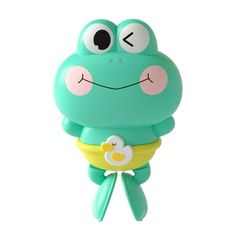 a green frog with big eyes and a yellow pacifier in it's mouth